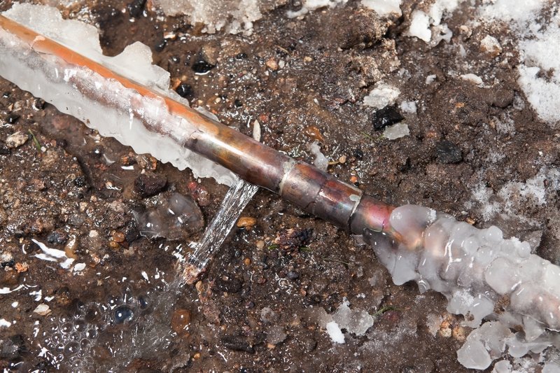 Hempstead Plumber thawing a frozen pipe in a Long Island basement