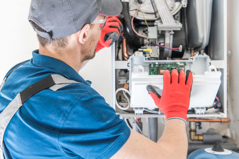 Hempstead Plumber repairing a gas boiler in a Long Island home