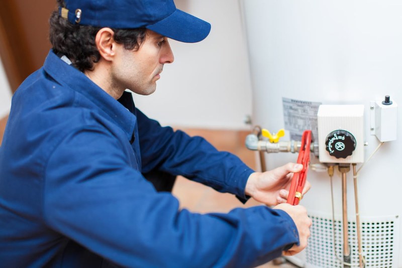 Hempstead Plumber repairing a residential water heater on Long Island